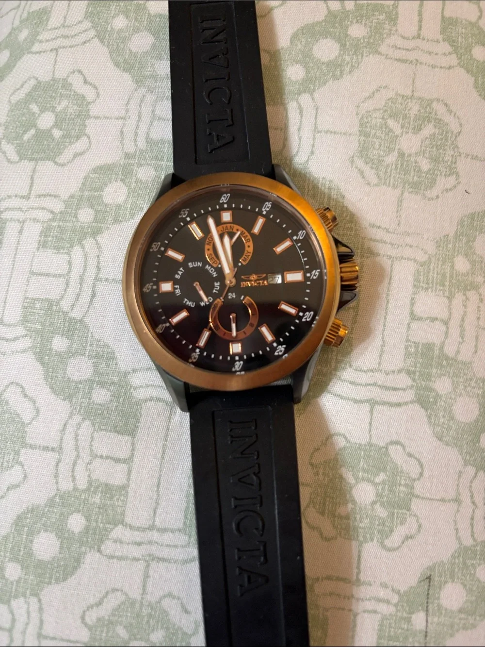 Invicta Specialty GMT watch, featuring a rose gold-tone case and a black dial.